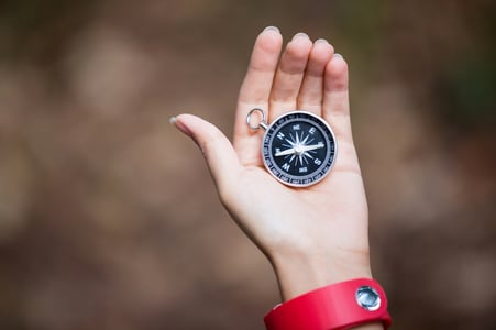 Compass in womans hand in the forest-1