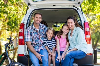 Happy family getting ready for road trip on a sunny day