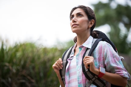 Woman hiking through a forest in the countryside-1